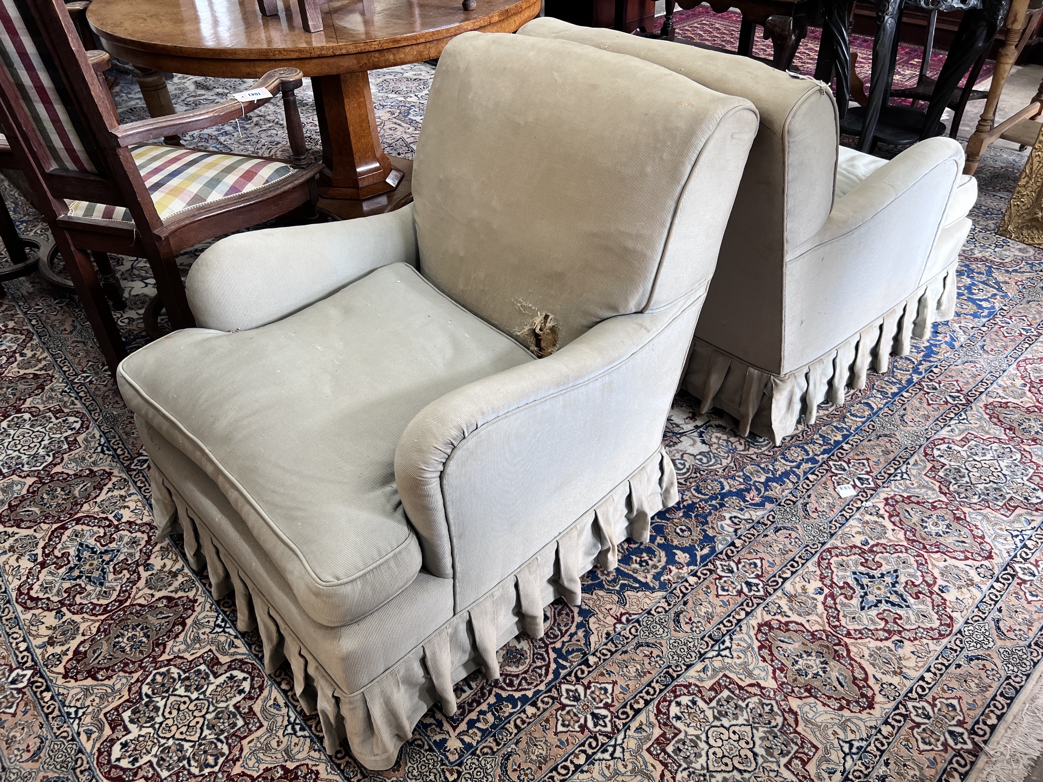 A pair of Howard style upholstered armchairs, width 69cm, depth 88cm, height 82cm